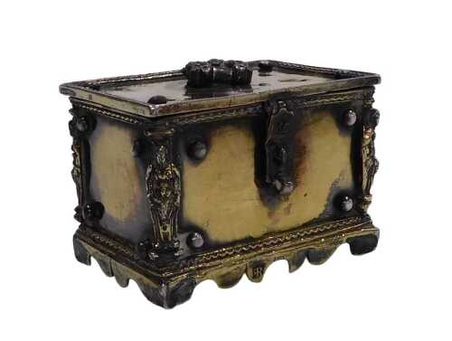 A Continental miniature casket, with an embossed handle to the lid, and four figural supports to...