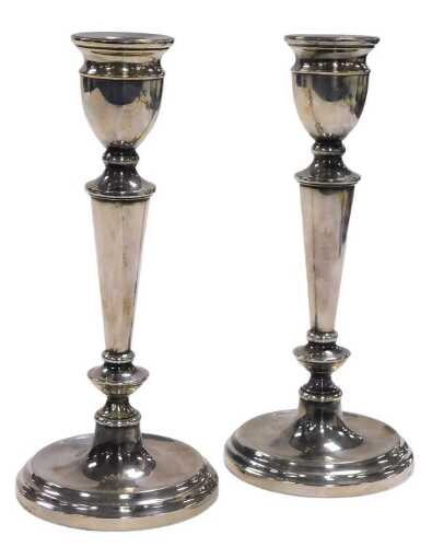 A pair of Elizabeth II loaded silver candlesticks, 14.97oz all in, 21cm high.