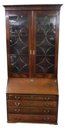 A George III mahogany bureau bookcase, the associated top with two astragal glazed doors, the...