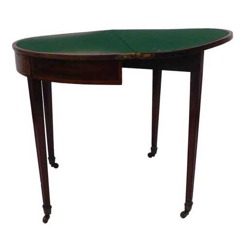 A George III mahogany and tulipwood crossbanded card table, the demi lune shaped hinged top...