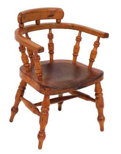 An early 20thC child's Windsor armchair, with an ash bow, solid seat, on turned legs.