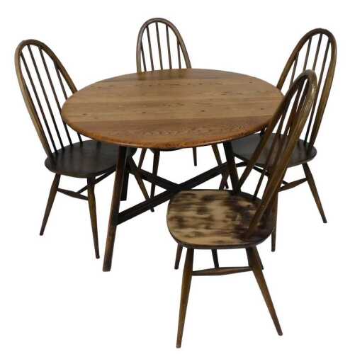 An Ercol elm oval drop leaf table, with a X shaped stretcher, 71cm high, 104cm wide, 64cm deep,...