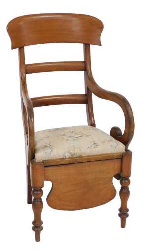 A Victorian mahogany commode armchair, with a bar back, hinged padded seat enclosing liner, etc.,...
