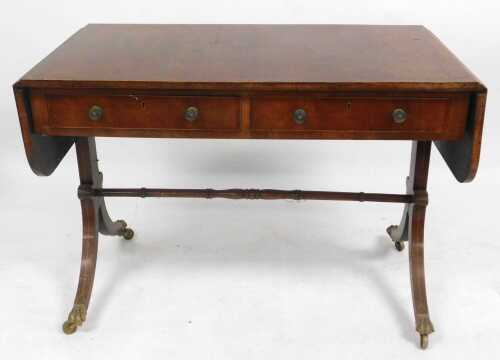 A Regency Style mahogany and boxwood strung sofa table, the crossbanded top with rounded ends,...