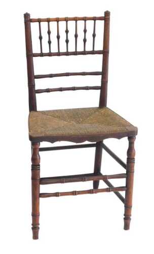 A Victorian walnut side chair, turned to simulate bamboo, with a rattan seat and turned legs.