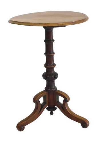 A Victorian walnut and mahogany occasional table, the circular top raised on a carved and turned...