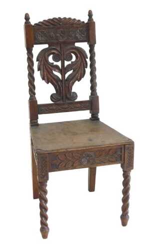 A Victorian carved oak side chair, the back carved with leaves and paterae, with a solid seat,...
