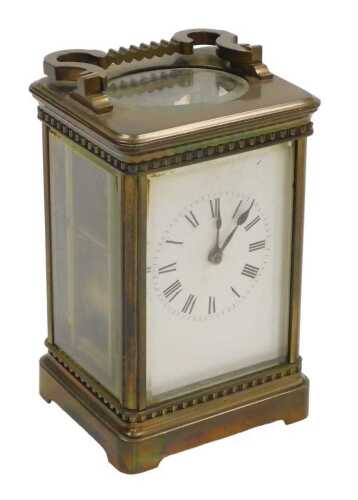 A late 19thC brass carriage clock, rectangular white dial bearing Roman numerals, twin barrel...
