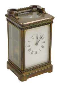 A late 19thC brass carriage clock, rectangular white dial bearing Roman numerals, twin barrel...