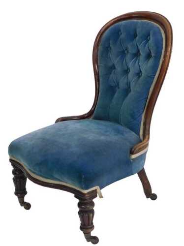 A Victorian walnut show frame nursing chair, with a blue upholstered button back, padded seat,...