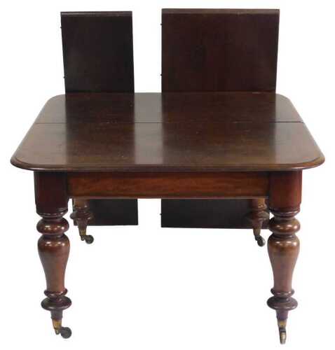 A Victorian mahogany extending dining table, the rectangular top with a moulded edge, and two...