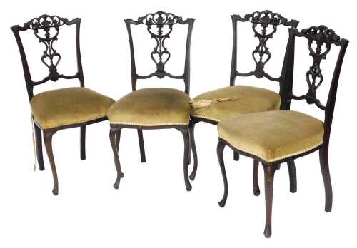 A set of four Victorian mahogany dining chairs, each with a pierced splat and a padded seat, on...
