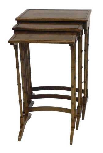 A Regency style nest of three mahogany tables, each rectangular top with a raised border and...