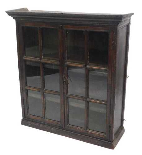 A late 18th/early 19thC oak cabinet, with a moulded cornice above two glazed doors, on a plinth,...