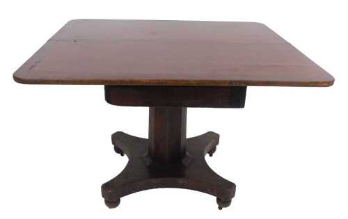 A late Georgian mahogany fold over tea table, with ebony line inlay, raised on an octagonal...