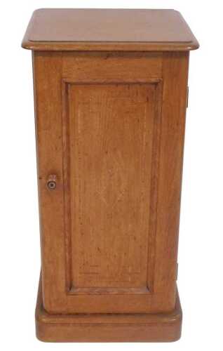 A pine and tulipwood crossbanded pot cupboard, the square top with a moulded edge, above a...