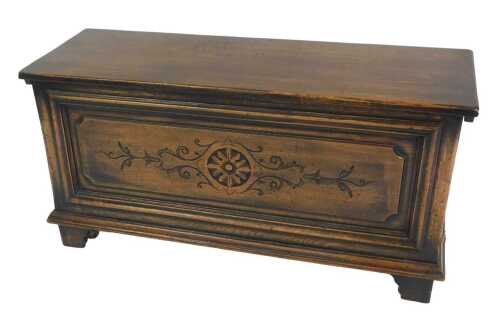 An oak chest, the rectangular hinged top revealing a vacant interior, above a frieze carved with...