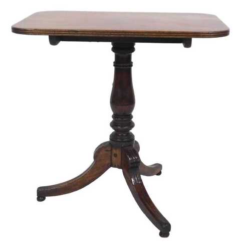 A Regency mahogany occasional table, the rectangular tilt top with a reeded edge, on a turned...