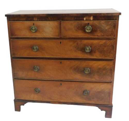 An early 19thC mahogany chest of drawers, the figured top with a crossbanded border, above two...
