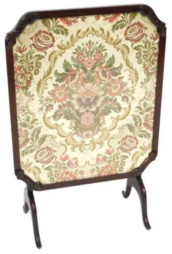 An early 20thC mahogany tilt top table fire screen, the glazed top fabric inset with an urn of...