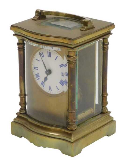 A late 19thC serpentine fronted brass cased carriage clock, circular enamel dial with blue Roman...