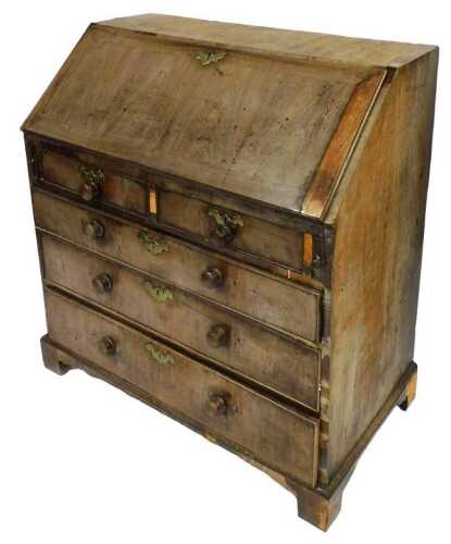 A George III mahogany bureau, the fall flap opening to reveal a central door flanked by a pair...