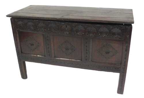 A late 17th/early 18thC oak coffer, the plank top above a front carved with lozenges and...