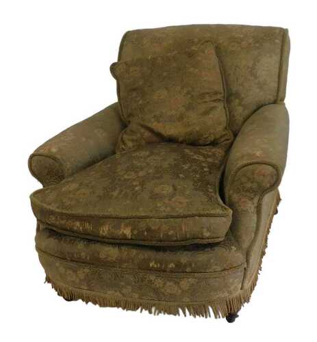 A Victorian deep seated armchair, in the manner of Howard and Sons, upholstered in gold floral...