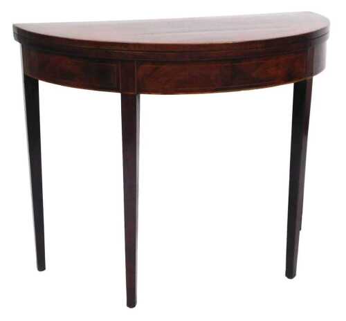 A George III mahogany D shaped card table, the crossbanded top, on square tapering legs, 74cm...