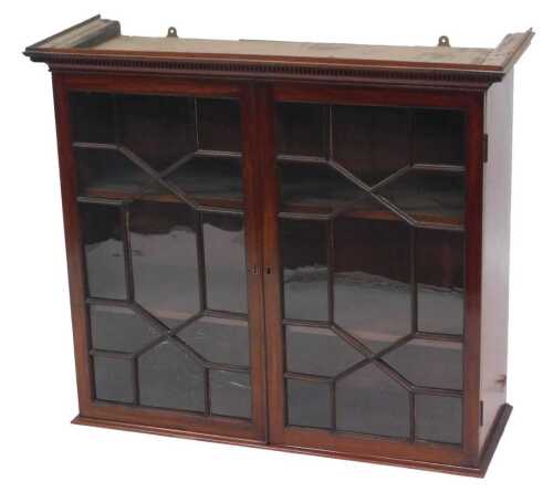 A 19thC mahogany wall cabinet, the top with a dentil cornice above two astragal glazed doors,...