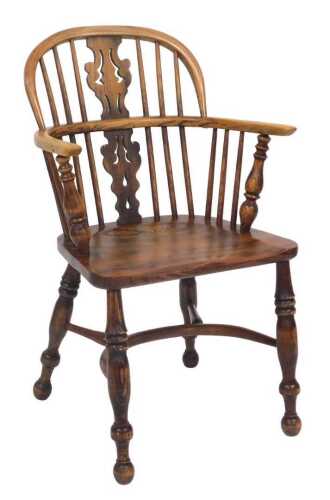 An ash and elm Windsor chair, with a pierced splat, and solid seat, on turned legs with a...
