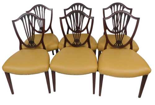 A set of six late 19thC mahogany side chairs, each with a shield shaped rail back, carved with...