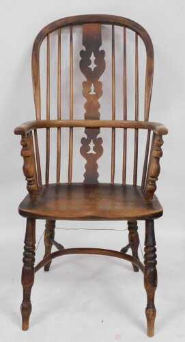 A 19thC elm and oak Windsor chair, with a carved vase shaped splat, and solid saddle seat,...