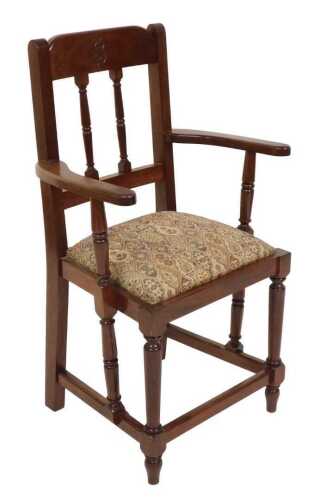 A mahogany elbow chair, the crest rail engraved with the initial B, with a tapestry fabric drop...
