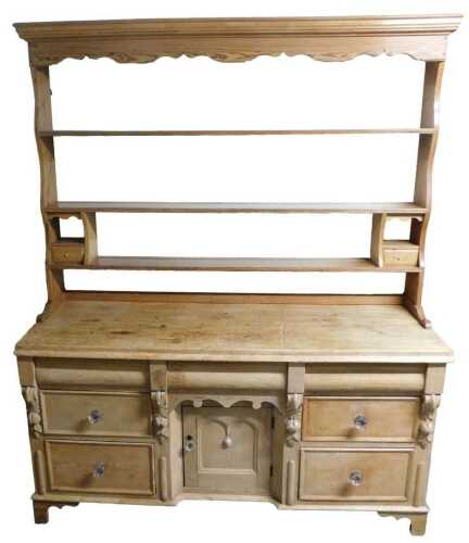 A Victorian and later pine dresser, the associated top with three shelves, the base with a...
