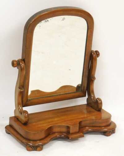 A Victorian mahogany swing frame dressing table mirror, with shaped supports and a serpentine...