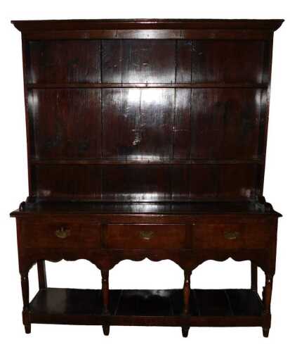 A late 18th/early 19thC oak dresser, the top with hooks to the plate shelves, the base with...
