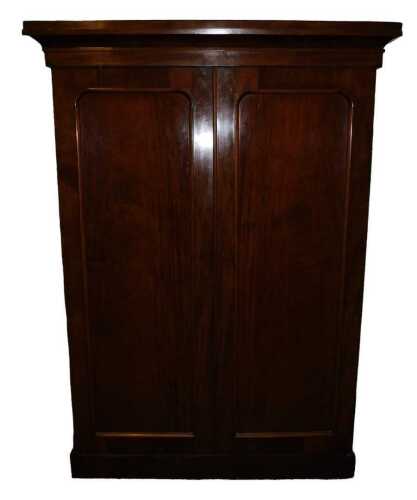 A Victorian mahogany wardrobe, the top with a moulded cornice above two panelled doors enclosing...