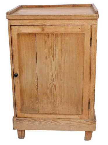 A 19thC pine side cabinet, with a raised top and a panelled door, on stiles, 86cm high, 54cm...