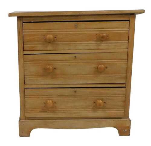 A stripped blonde walnut chest of drawers, the rectangular top with a moulded edge above three...