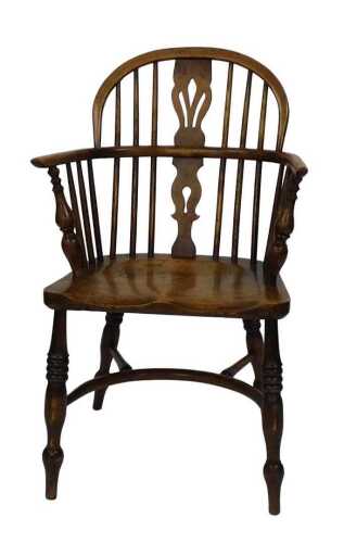 An ash and oak Windsor chair, with a pierced splat, solid seat, on turned legs with a crinoline...