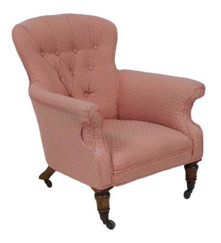 A Victorian mahogany armchair, upholstered in pink fabric, with a button back, turned legs and...