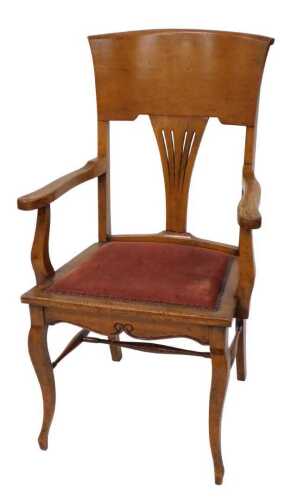 An Edwardian oak office armchair, with a pierced back, padded seat, on cabriole legs.