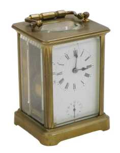 A late 19thC brass alarm carriage clock, rectangular fascia with circular enamel dial bearing...