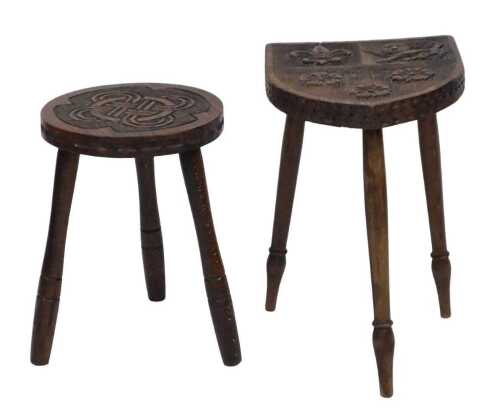 A carved oak stool, the shield shaped top decorated with a crest of lion, fleur de lys and roses,...