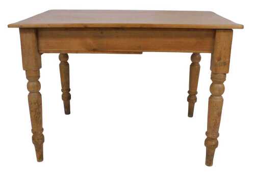 A pine kitchen table, the rectangular planked top above a frieze drawer, with turned wooden...