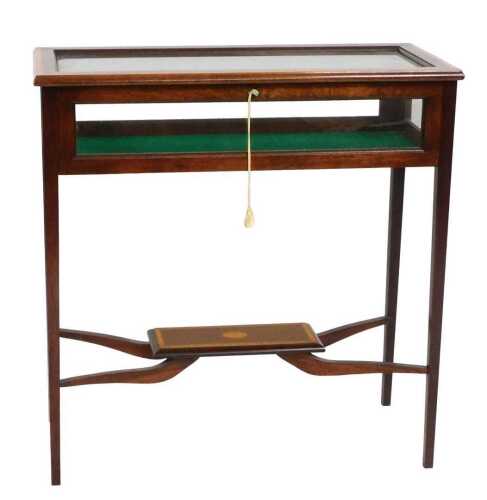 A mahogany and satinwood crossbanded bijouterie table, the hinged top revealing a baize lined...