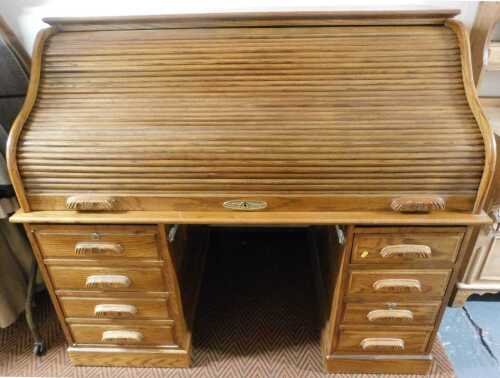 A modern oak roll top desk, the tambour front enclosing a fitted interior, stamped County Desk,...
