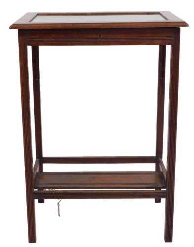 An Edwardian walnut bijouterie table, the hinged top enclosing a baize lined interior, on reeded...