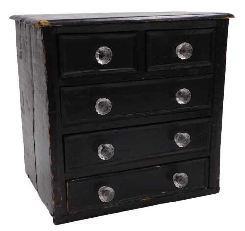 An ebonised pine small chest, the rectangular top with a moulded edge above two short and three...
